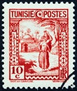 TUNISIA - CIRCA 1931: A stamp printed in Tunisia shows woman carrying water.