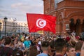 Tunisian football fans with flag on red Square. Football world Cup.