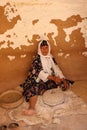 Tunisian woman grinding grains