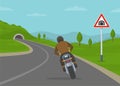 Tunnel ahead warning road or traffic sign. Back view of a cornering or turning bike on motorway. Royalty Free Stock Photo