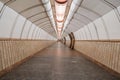 Tunnel of empty heptagonal long futuristic underpass, lined with ceramic tiles