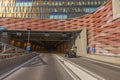 Tunnel entrance in downtown Stockholm with passing cars under colorful construction. Sweden. Royalty Free Stock Photo