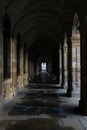 Tunnel formed by stone arches in the Plaza del Obradoiro in Gali