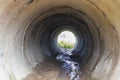 Tunnel made of reinforced concrete pipes for drainage of rainwater under the road. View through a large pipe Royalty Free Stock Photo