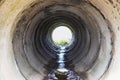 Tunnel made of reinforced concrete pipes for drainage of rainwater under the road. View through a large pipe Royalty Free Stock Photo