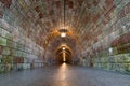 Tunnel running through mountain illuminated with electric lights. Royalty Free Stock Photo