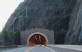 Tunnel through Solid Rock with Lights and a Car Inside