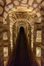 Tunnel with stone arches in the catacombs of Paris France