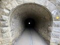 Tunnels through the cliffs at the foot of the Churfirsten mountain range on the road along the shore of Lake Walen or Walensee Royalty Free Stock Photo