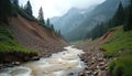 Turbid mountain river with strong current flows through remote valley impacted by recent large rockslide. Massive debris, rocks, Royalty Free Stock Photo