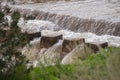 A turbid, muddy rushing stream of overflowing river water. Flood Royalty Free Stock Photo