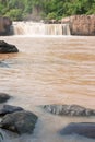 Turbid water of tropical waterfall after hard rain