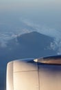 Turbine Engine with volcanic mountain surrounded by clouds in the background