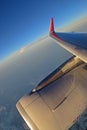 Turbine Engine, wing and red winglet with white clouds and deep blue sky in the background Royalty Free Stock Photo