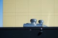 Turbine rotating exhaust ventilation installed on the roof of a modern house. Yellow-blue background. Photo