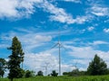 Turbine or windmill in green field isolated blue sky