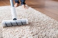 The turbo brush of a cordless vacuum cleaner cleans the carpet in the house With a clean stripe Royalty Free Stock Photo