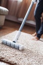 The turbo brush of a cordless vacuum cleaner cleans the carpet in the house in close-up Royalty Free Stock Photo