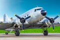 Turbo-prop vintage airplane parked at the airport, shiny metal fuselage aircraft. Royalty Free Stock Photo