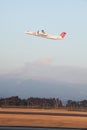 Turboprop airplane takes off while volcano erupts