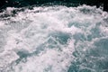 Turbulence made by foam of sea water from a high-speed yacht on surface of sea. Blue sea waves with lot of sea foam. Royalty Free Stock Photo