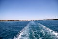 Turbulence made by foam of sea water from a high-speed yacht on surface of sea. Blue sea waves with lot of sea foam.