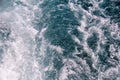 Turbulence made by foam of sea water from a high-speed yacht on surface of sea. Blue sea waves with lot of sea foam. Royalty Free Stock Photo