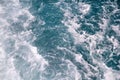 Turbulence made by foam of sea water from a high-speed yacht on surface of sea. Blue sea waves with lot of sea foam. Royalty Free Stock Photo