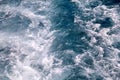 Turbulence made by foam of sea water from a high-speed yacht on surface of sea. Blue sea waves with lot of sea foam. Royalty Free Stock Photo