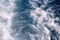 Turbulence made by foam of sea water from a high-speed yacht on surface of sea. Blue sea waves with lot of sea foam.