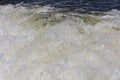 Turbulent water, showing churning foam, bubbles, and surface tension. Royalty Free Stock Photo