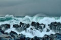 turbulent waves of Pacific ocean and rugged beauty of basalt rocks Royalty Free Stock Photo