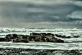 waves of Pacific ocean and rugged beauty of basalt rocks