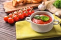 Tureen with tasty tomato sauce on wooden table