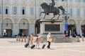 Turin, Italy. June 10, 2021. View of Piazza San Carlo in the morning on a sunny day with family walking carrying a trolley bag by