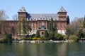 Valentino castle red bricks facade and Po river in a spring day in Piedmont, Turin, Italy