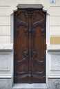 Art Nouveau ancient wooden door with floral decorations in Turin, Italy