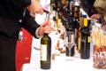 Turin, Piedmont, Italy. -10/26/2009- Fair `Wine show`, sommelier uncork a bottle of wine to taste.