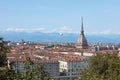 Turin rooftops view, Mole Antonelliana tower and hot air balloon in a summer day in Italy