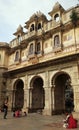 Turist photographing locals at Gangaur Ghat, the city centre`s main access point to Lake Pichola Udaipur