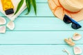 Planning vacation to the seaside with straw hat, sun glasses, sunscreen lotion on mint green background top view mock-up Royalty Free Stock Photo