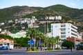 Ali Dizdaroglu Sk. street with a bus station in the background of mountains in Alanya. Tropical