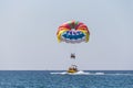 Extreme entertainment, tourists on a parachute climb on a rope from a boat