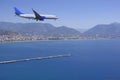 The plane flies over the Mediterranean Sea over the Turkish resort towns. Royalty Free Stock Photo