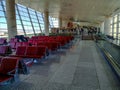 Large bright hall with many red seats in the departure area of Ankara Esenboga Airport ESB.