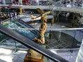 Sculpture of a boy with airplane inside Ankara Esenboga Airport. Bronze golden child holding a