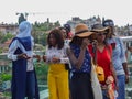 Turkey, Antalya, May 10, 2018. Group of young African women in bright clothes on the viewing platform in the old city inspecting t