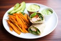 turkey avocado wrap, side of sweet potato fries Royalty Free Stock Photo