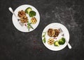 Turkey or chicken cutlets meatballs zucchini and broccoli in white plates on black background  top view. Healthy balanced food Royalty Free Stock Photo