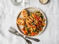 Turkey cutlets grill, vegetables steer fry and white sesame on plate on the table. Top view Royalty Free Stock Photo